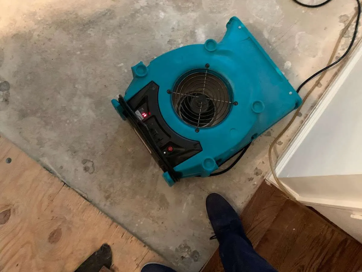 Air mover drying subfloor during Commercial Water Damage Restoration in Meadville
